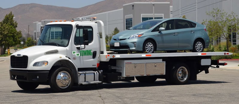 photo of flatbed towing services being rendered 